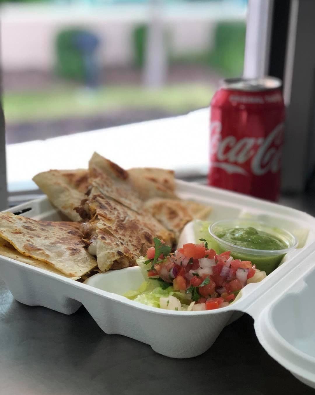 Quesadilla with pico de gallo and salsa verde served at a taco truck catering event