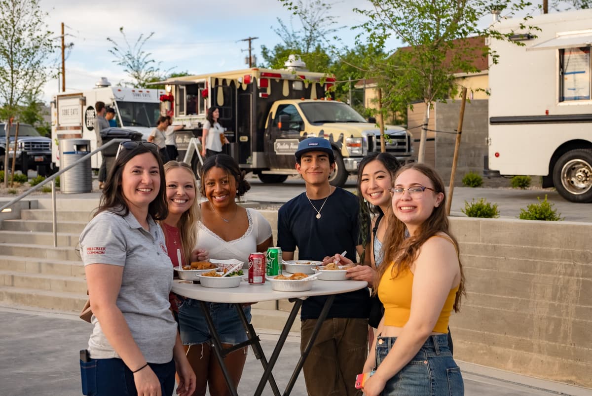 group of friends sharing food at a weekly food truck night event