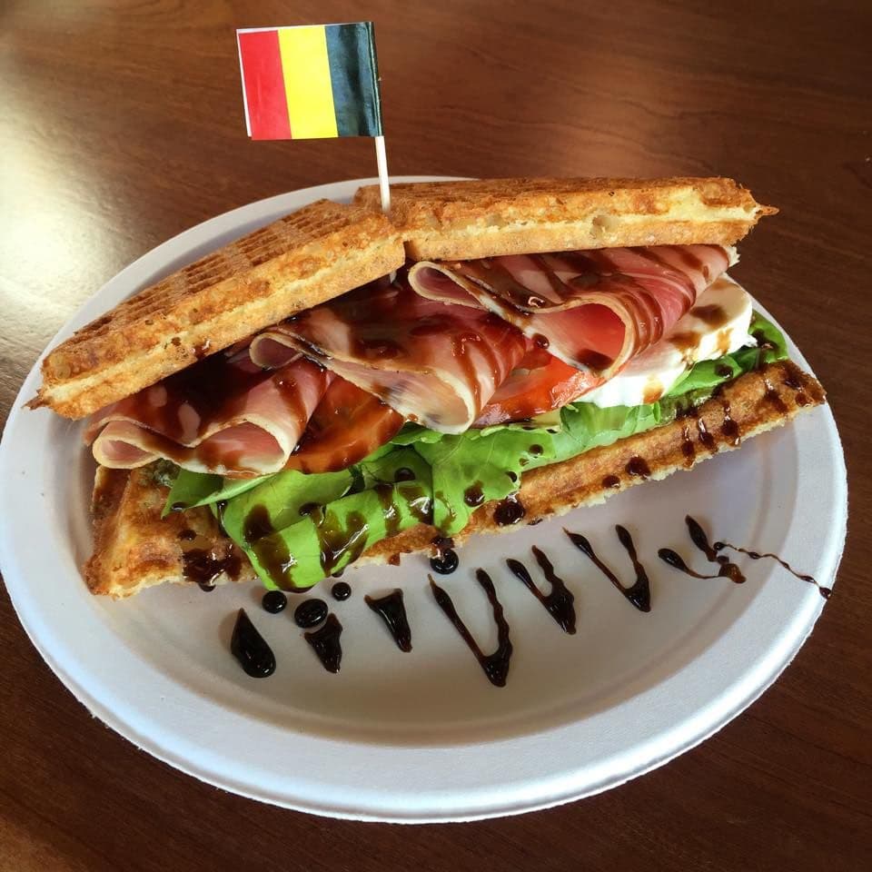 Belgian waffle sandwich with prosciutto, mozzarella, and balsamic drizzle, a seasonal office lunch idea