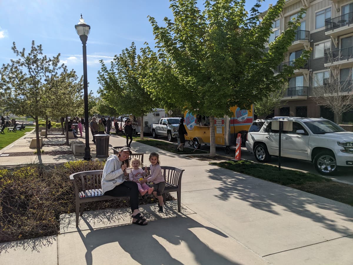 community event food ideas with food trucks lined up at a neighborhood park