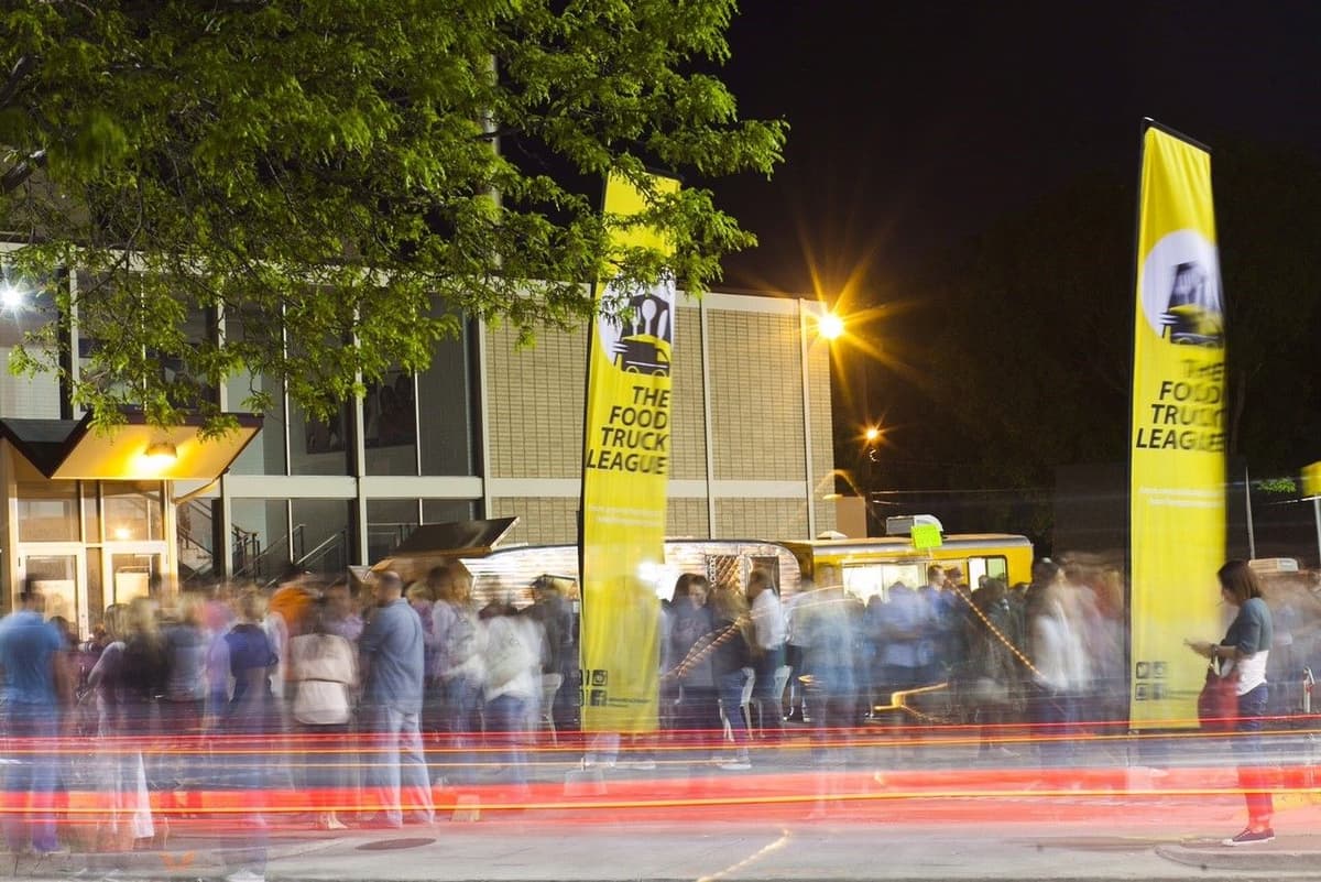Food Truck League banners at a nighttime food truck catering event